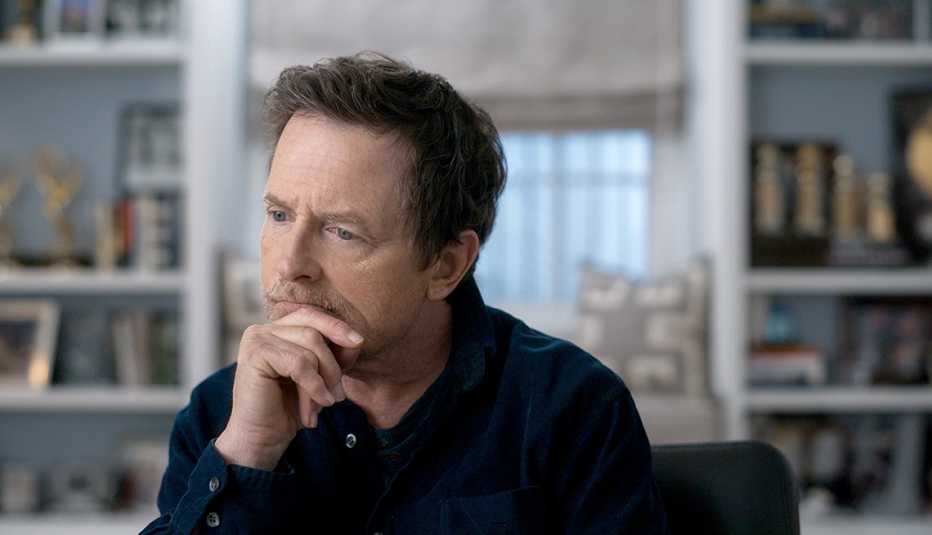 michael j fox with hand on chin in a still from still the movie