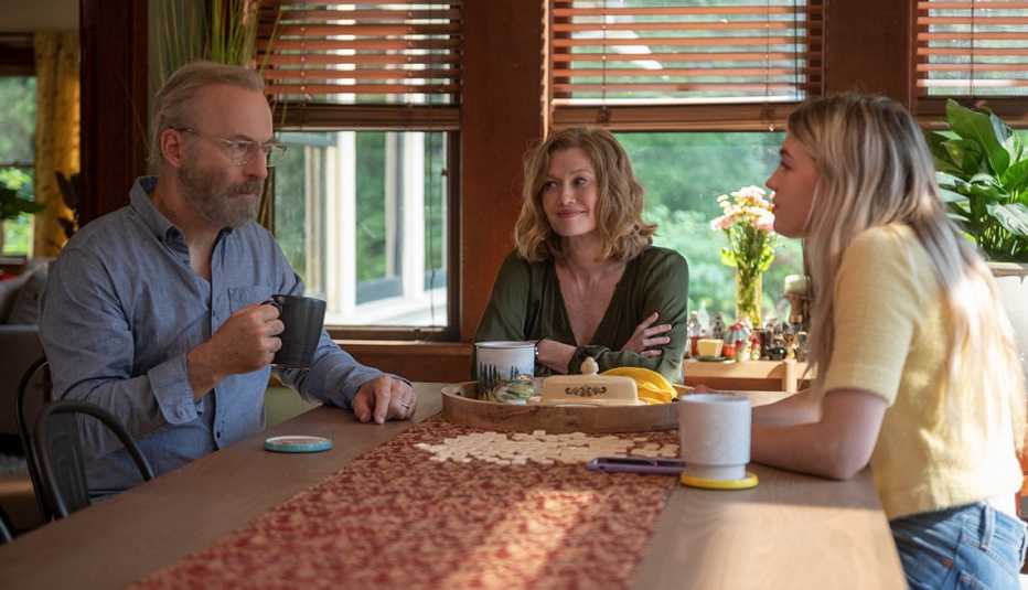bob odenkirk as hank, mireille enos as lily and olivia scott welch as julie sitting at table in a still from straight man