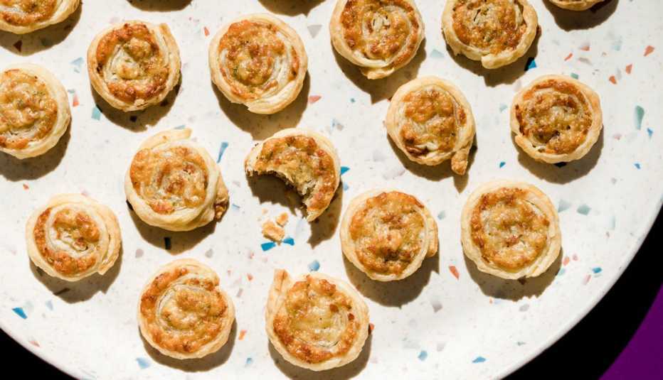 round puff pastries on a dish stuffed with cheese and meat