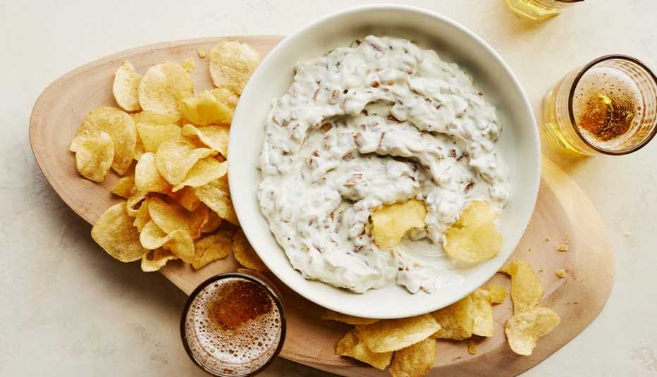 french onion dip in bowl with chips on platter around it