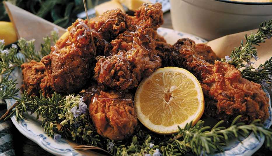 fried chicken with lemon next to it on plate