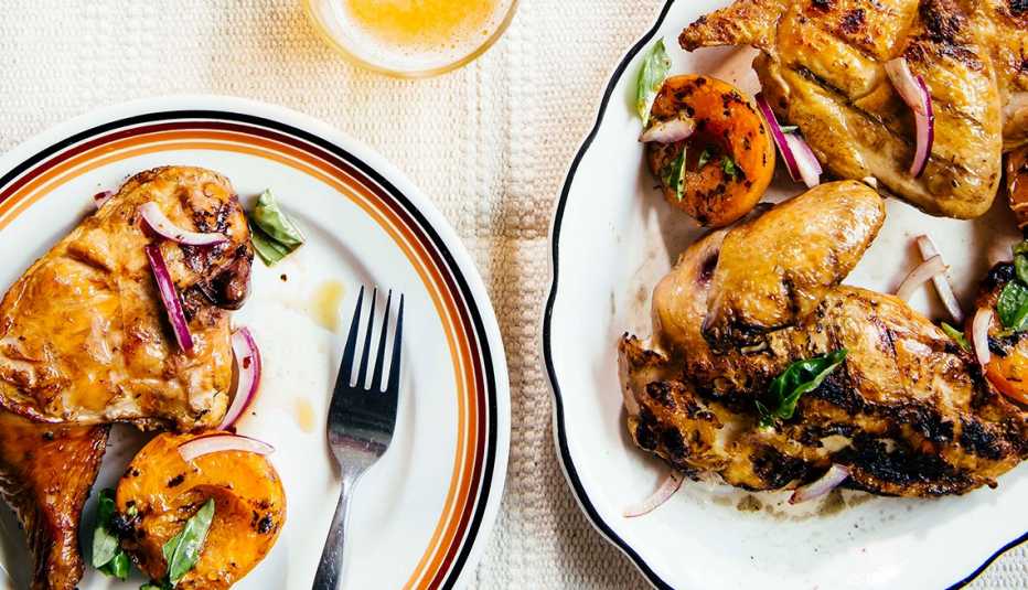 grilled chicken with apricots, red onion and basil on two plates