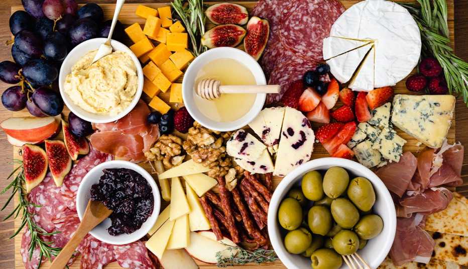 charcuterie board with meats, cheeses, spreads and olives