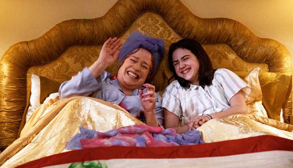 Kathy Bates as Sylvia Simon and Abby Ryder Fortson as Margaret Simon laughing in bed in a still from Are You There God? It’s Me, Margaret.