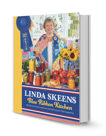 book with linda skeens on cover with all sorts of food on table in front of her; blue first place ribon in upper left corner and on her shirt; words linda skeens blue ribbon kitchen on bottom