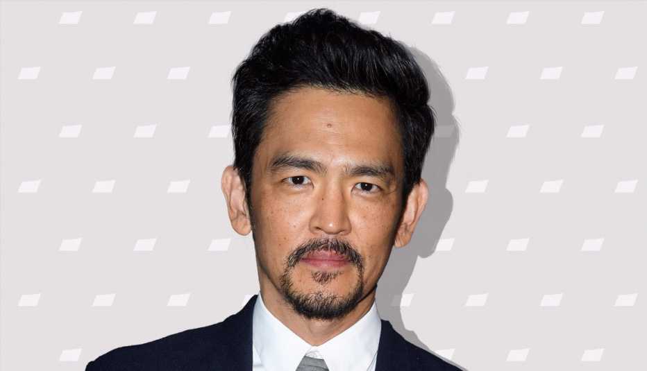 john cho against light gray background with mini shapes