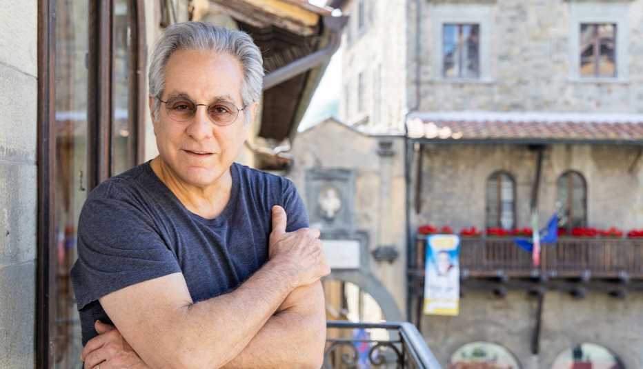 max weinberg on a balcony with another building to his left