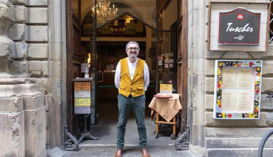 outside of tuscher caffé; man standing in front of door