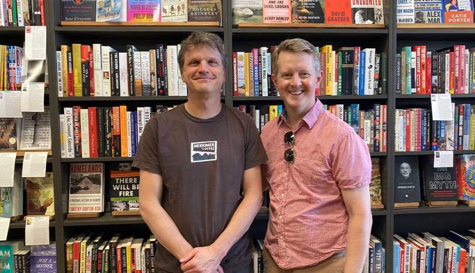 tom nissley and ken jennings in front of bookcase with numerous books