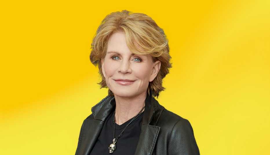 patricia cornwell wearing black shirt and jacket against yellow ombre background