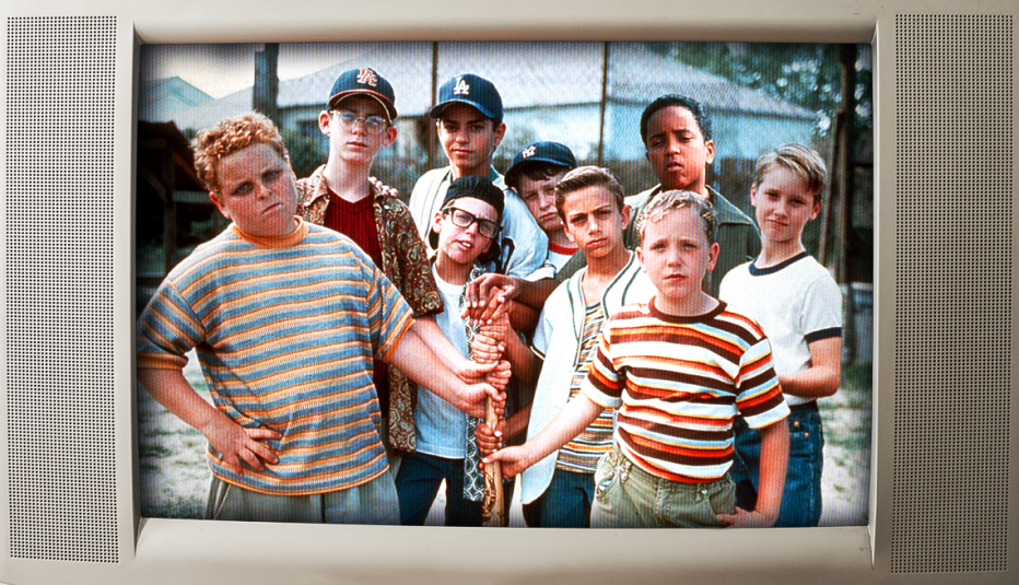 the boys from the movie sandlot all gathered around and holding a stick while facing the camera, some wearing hats and most looking tough, with a border meant to look like a 1990s-television
