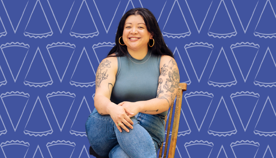 stacey mei yan fong sitting on chair against blue background with pie slice cutouts on it
