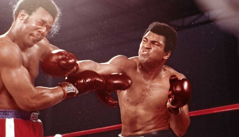 Muhammad Ali and George Foreman fighting in boxing ring