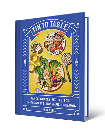 book cover with words tin to table, fancy, snacky recipes for tin-thusiasts and a-fish-ionados, anna hezel