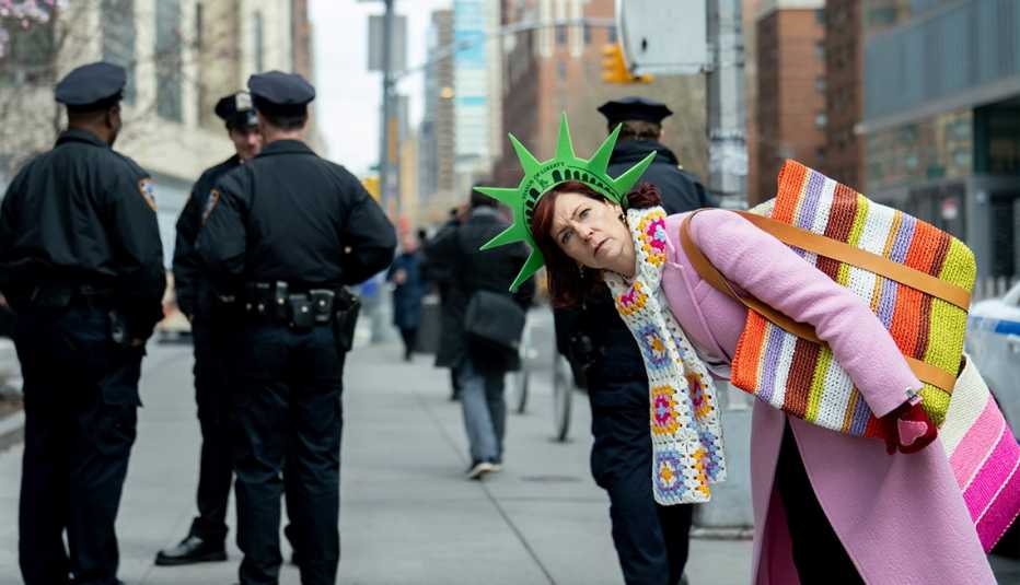 carrie preston in front of police officers in a still from elsbeth