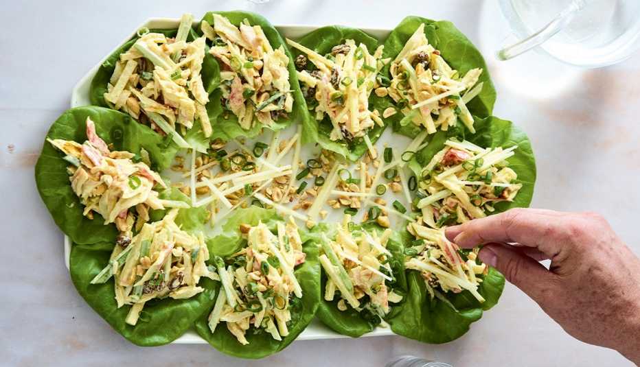 Salad with big lettuce leaves and shredded imitation crab on dish