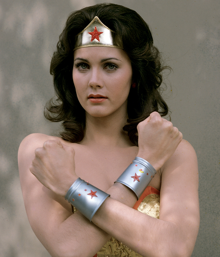 lynda carter dressed as wonder woman with arms crossed across chest
