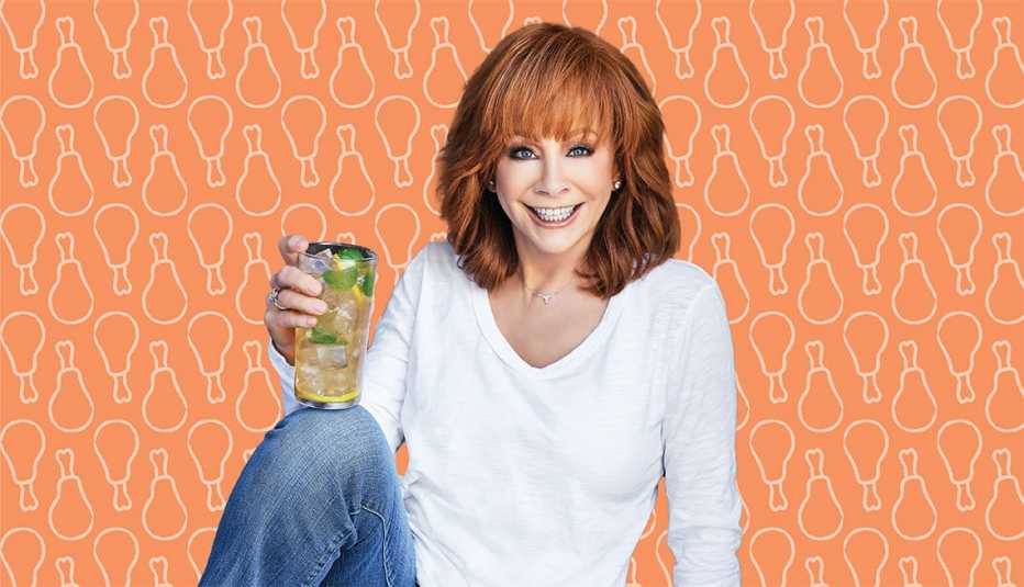 reba mcentire holding glass with drink in it against orange background with outlines of chicken drumsticks on it 