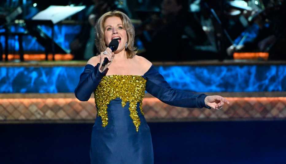 Renée Fleming holding microphone and singing on stage