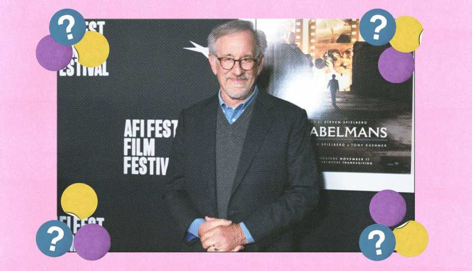 Steven Spielberg at the AFI Fest screening standing in front of a poster for The Fabelmans movie