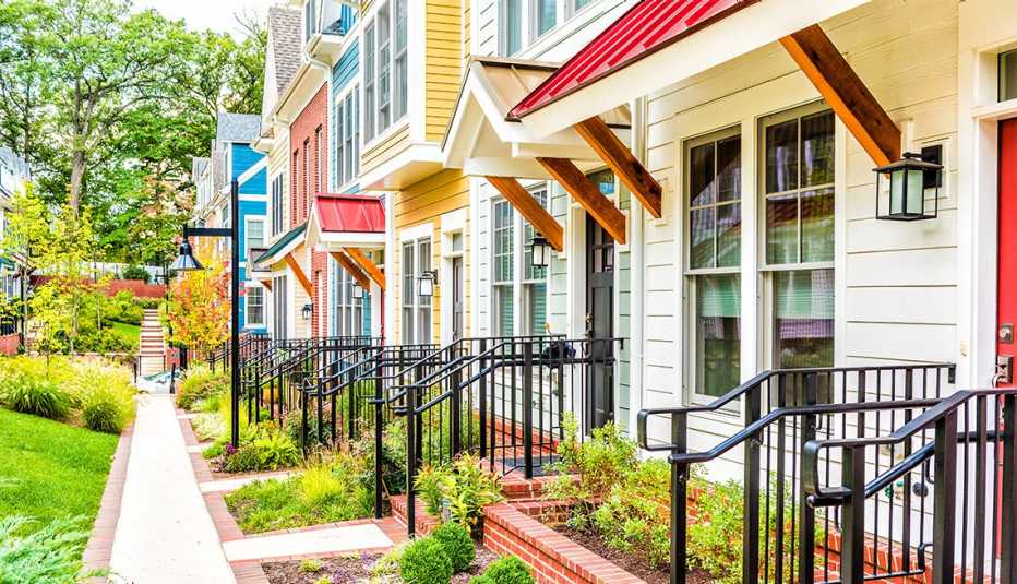 Row of colorful, red, yellow, blue, white, green painted residential townhouses