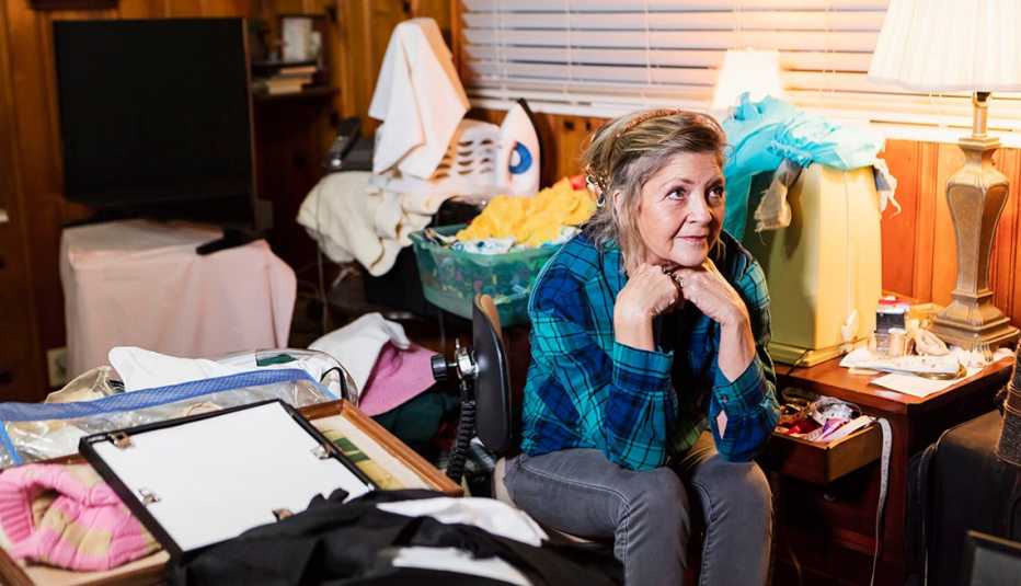 woman sitting in a cluttered room
