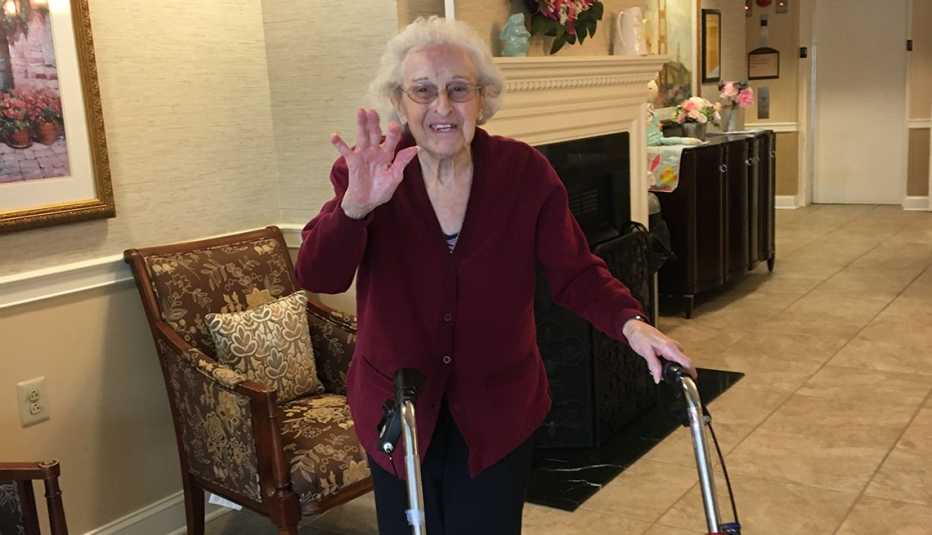 Ida smiling and waiving inside her assisted living home
