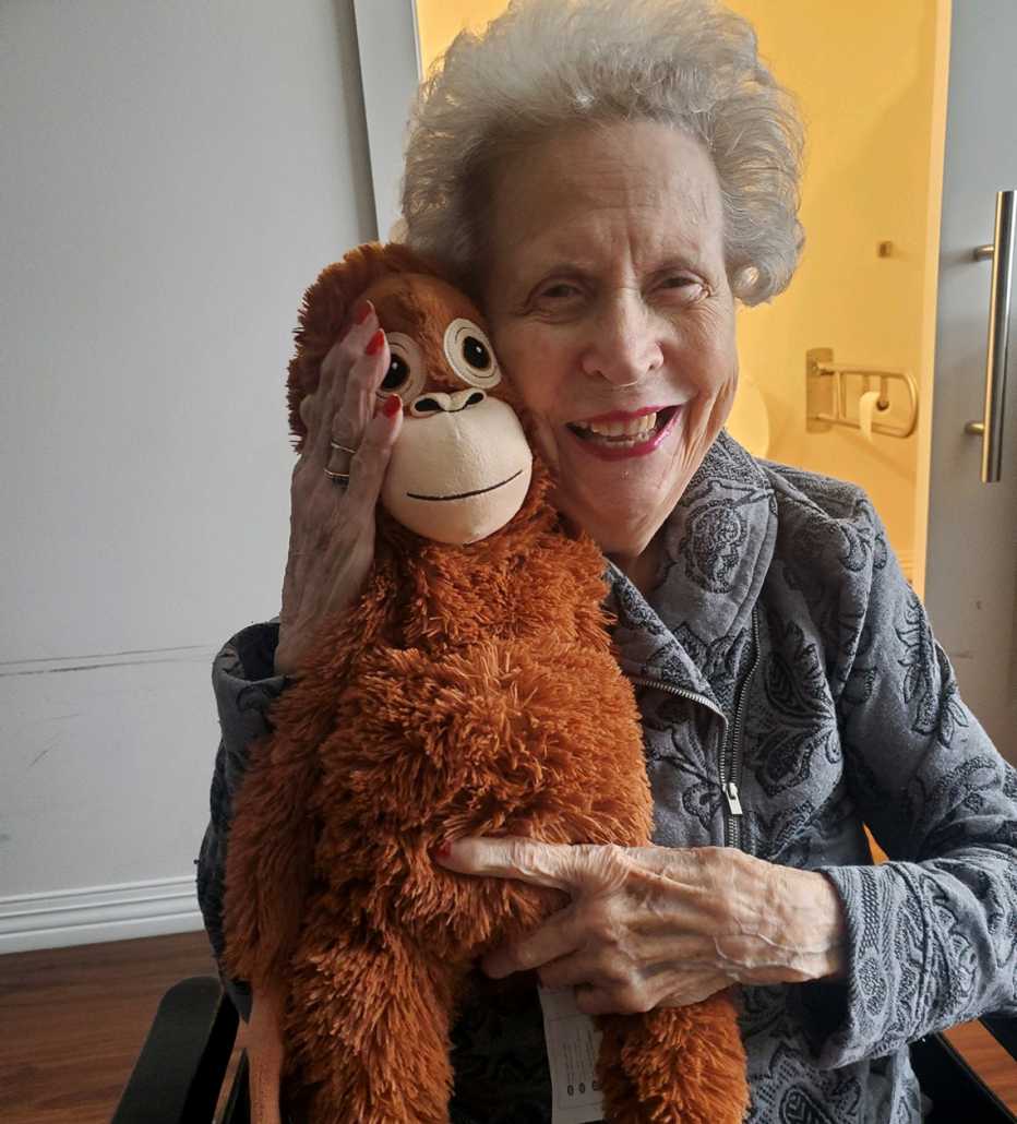 Wilma holding  a stuffed animal monkey
