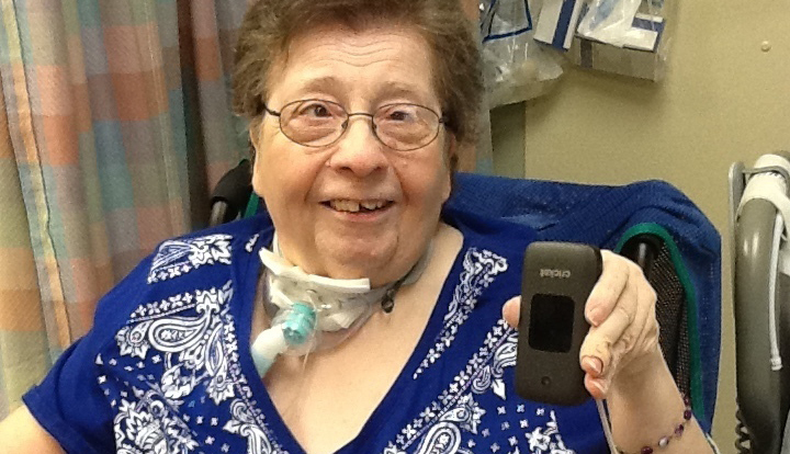 ronni ehrhart in her nursing home room holder her new smart phone