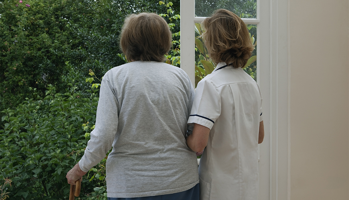 woman being assisted by a nurse at an assisted living facility