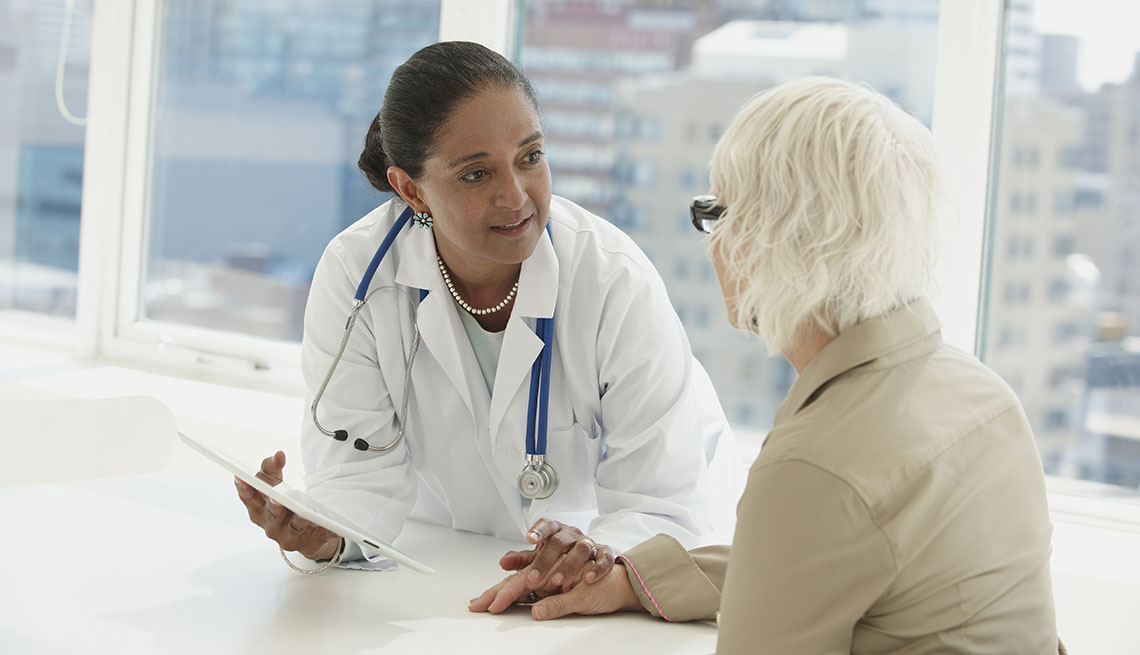 woman discussing paperwork with her doctor