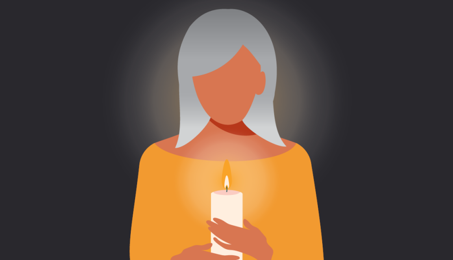 a woman holding a lit candle