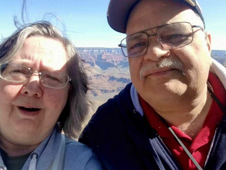 diane burk and her husband jack in a family photo taken at the grand canyon