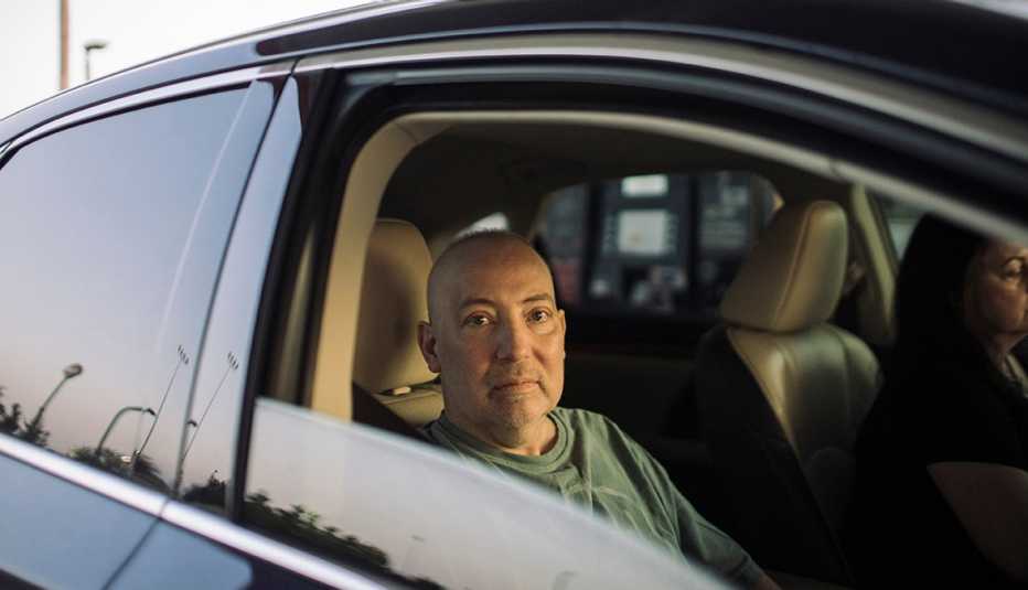 ethan frank collins sits in the passenger seat of the car while his wife drives to his medical testing appointment