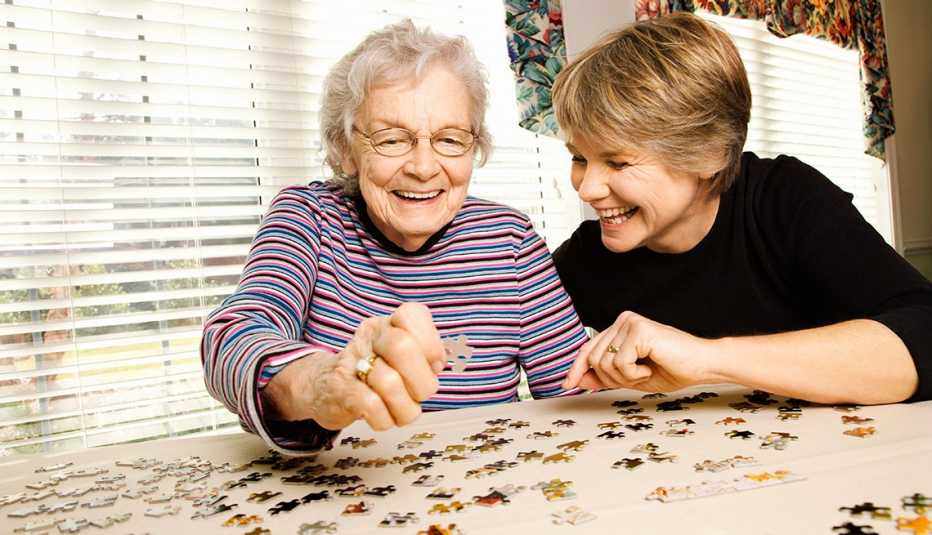 Adult woman doing a puzzle with her mother