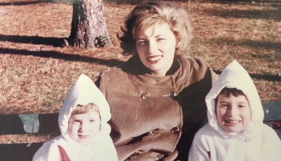 Annabelle Gurwitch as a young child, sitting in the park with her mother and sister