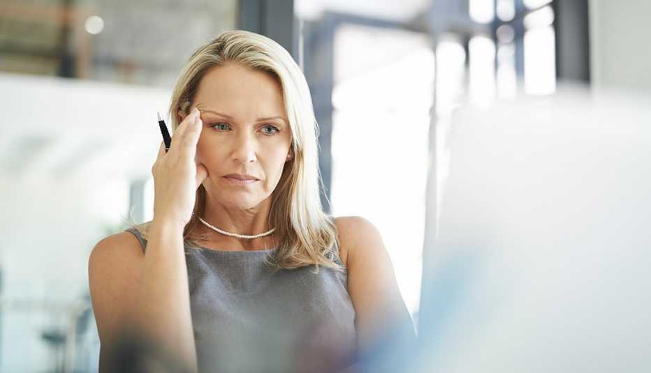 Mature woman looks frustrated while at work