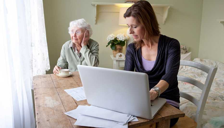 Woman working from home while caregiving for mother