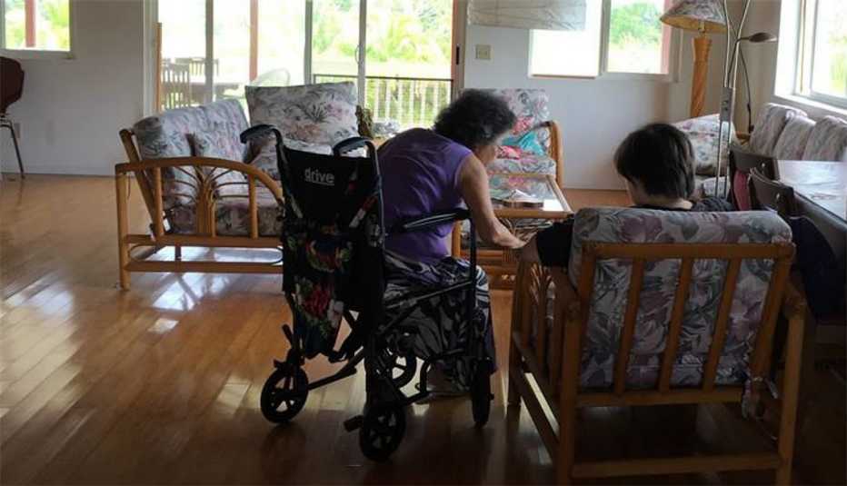 Frances Kai-Hwa Wang's mother and daughter sitting in the living room going over bills to be paid.