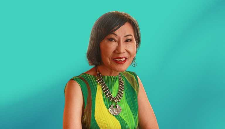 Amy Tan against teal ombre background