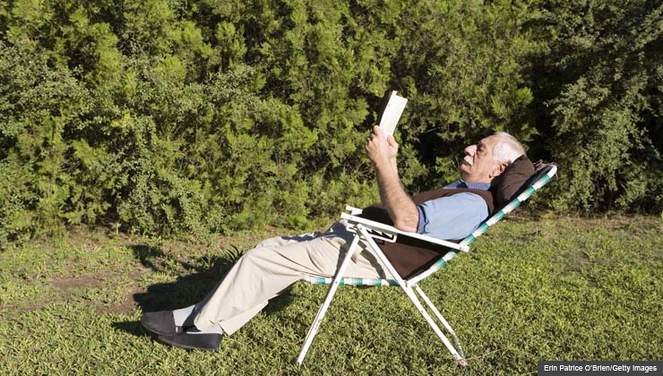 Classic literature and popular novels for seniors- Great Gatsby book cover- mature man reading book outdoors