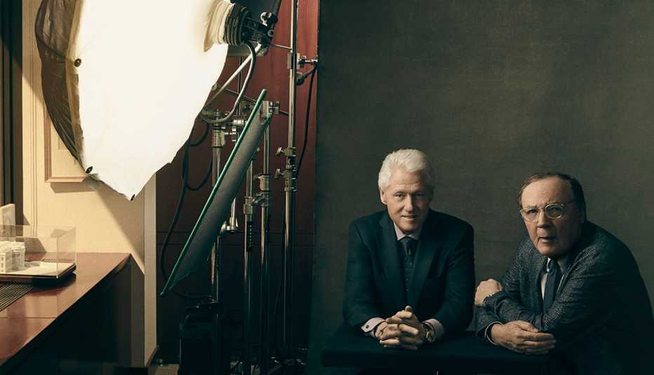 Bill Clinton and James Patterson sitting in front of a light