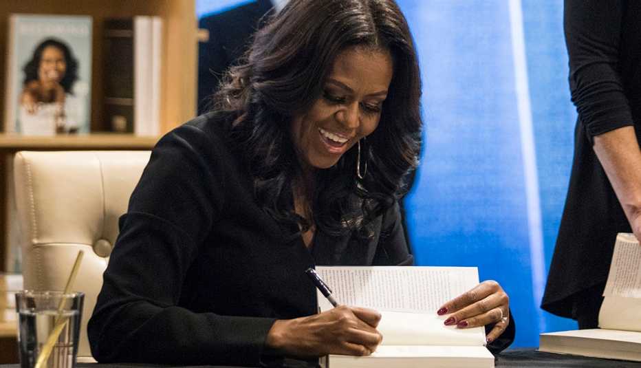 Michelle Obama signing a book