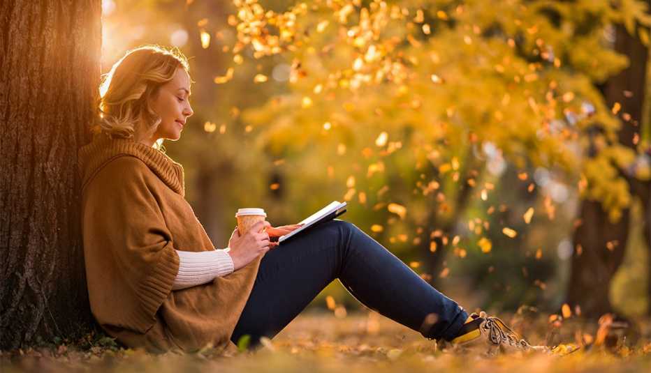 Woman sitting in the park and reading a novel