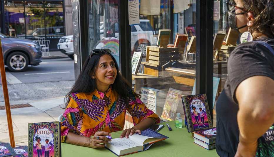 Author Samira Ahmed talks with Laura Gluckman during a book signing at Women & Children First bookstore