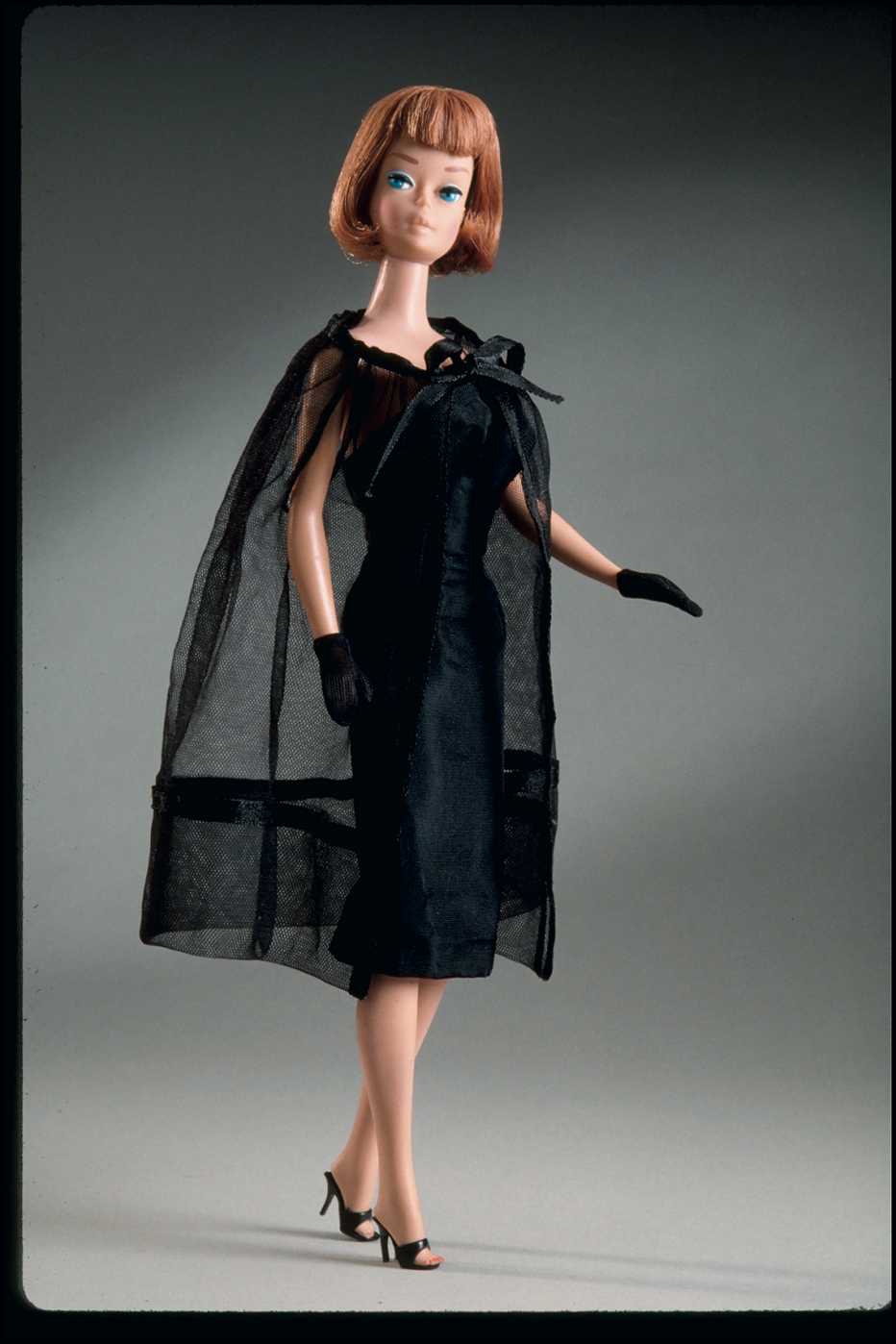 a barbie doll wearing a black cocktail dress