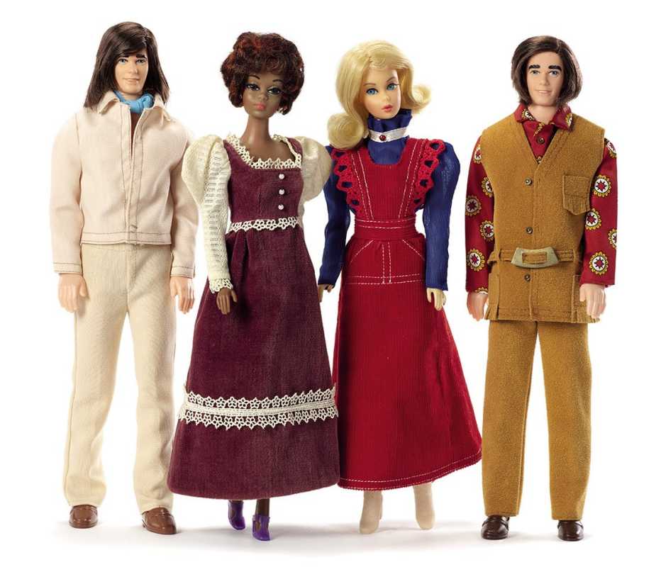 two barbie dolls in long dresses and two ken dolls in leisure suits