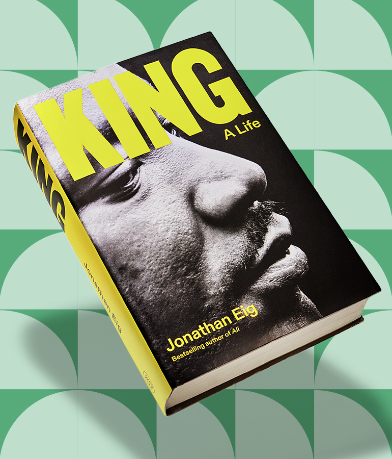 king: a life by jonathan eig. book floating above a green patterned background
