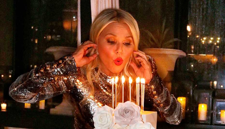 Christie Brinkley blowing out candles on her cake