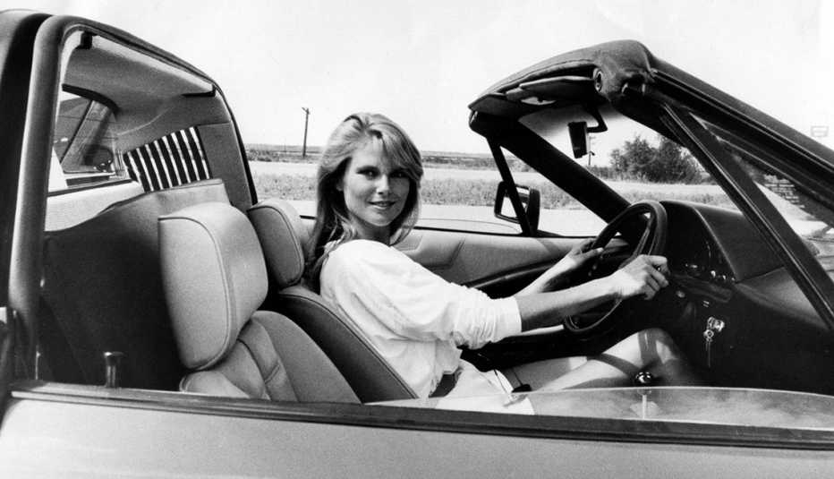 Christie Brinkley sitting in a convertible 